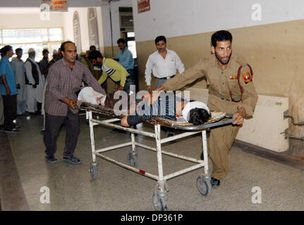 Jun 22, 2006; Spore, Kashmir, INDIA; Hospital staff and civilians rush a seriously wounded Kashmiri civilian for treatment to a local hospital, following a grenade blast in north Kashmir, in Srinagar, the summer capital of Indian Kashmir, 22 June, 2006. A hand grenade exploded Thursday during a sermon by a well-known Islamic religious leader addressing dozens of Muslim followers at Stock Photo