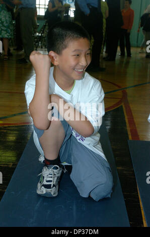 Jun 22, 2006; Manhattan, New York, USA; PS 1 4th grader JIMMY CHEN flexes his muscles as Schools Chancellor Joel Klein of the New York City Department of Education (DOE) announces the release of more than 235,000 NYC FITNESSGRAM reports to parents and students in a press conference at PS 1 in lower Manhattan. The individualized reports, based on results of standards-based fitness a Stock Photo