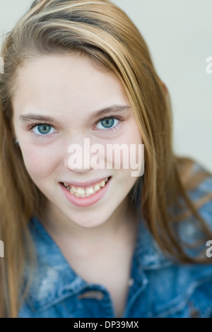 Close-up Portrait of pre-teen girl smiling and looking at camera Stock Photo