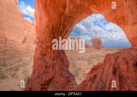 Cove Arch framing Double Arch, Arches National Park, Utah Windows Section Entrada sandstone Stock Photo