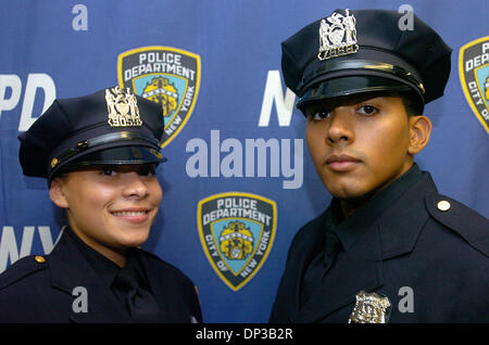 Jun 26, 2006; Manhattan, New York, USA; Newly sworn in police officers MARICRUZ CRESPO JR. (L) and EDWIN CRESPO (R), both children were born at the same time July 18, 1983 and both are now Police Officers, following in their mother's footsteps. New York City Police Academy Graduation Ceremony for 1,213 new police officers at Madison Square Garden. This is the eighth class of office Stock Photo