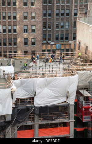 Construction of the building. Workers unrecognizable make metal ...