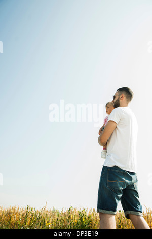 Father Holding Baby Daughter Outdoors, Mannheim, Baden-Wurttemberg, Germany Stock Photo