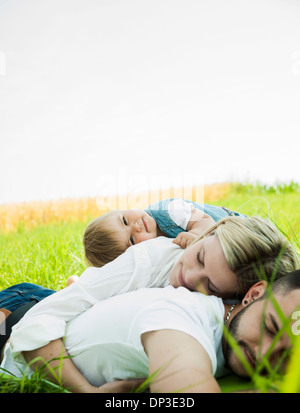 Family Sleeping in Grass, Mannheim, Baden-Wurttemberg, Germany Stock Photo