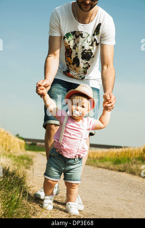 Father and Baby Daughter Walking Outdoors, Mannheim, Baden-Wurttemberg, Germany Stock Photo