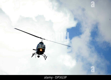 Jul 05, 2006; Port St. Lucie, FL, USA; A police helicopter aids in the search for a suspect involved in a purse robbery behind the East Port Plaza at the corner of Walton and Federal Highway on Wednesday afternoon. One of two suspects was apprehended.  Mandatory Credit: Photo by Amanda Voisard/Palm Beach Post/ZUMA Press. (©) Copyright 2006 by Palm Beach Post Stock Photo