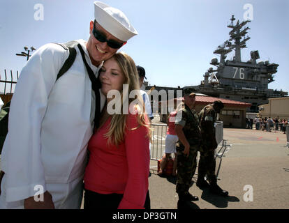 Jul 06, 2006; San Diego, CA, USA; US Navy Petty Officer 3rd Class ERIC WILLIAMS of Benton, Illinois left, and MISTY CAROTHERS, right, of Gardners, Pennsylvania meet each other for the first time after WILLIAMS, a crewmember on the U.S.S. Ronald Reagan arrived at Naval Air Station North Island at the conclusion of the shipÕs six-month plus maiden operational deployment which include Stock Photo