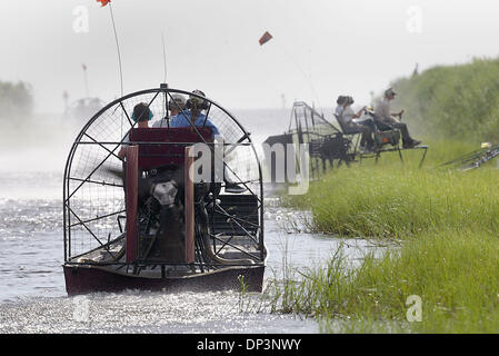 Jul 14, 2006; Clewiston, FL, USA; Alligator egg hunters navigate their airboats through the marsh along Lake Okeechobee in search of nests.  Florida Fish and Wildlife officials, Alligator farmers, and volunteers, hunt for alligator eggs each summer in the thick marsh of Lake Okeechobee.  In an effort to control the alligator population, officials report that egg hunters recovered 1 Stock Photo