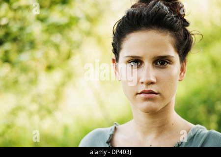 Close-up portrait of teenaged girl outdoors in nature, looking at camera, Germany Stock Photo