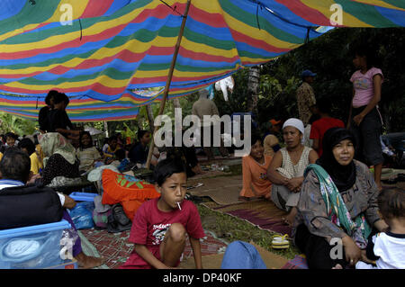 Jul 20, 2006; Ciamis, West Java, INDONESIA; Residents of Pangandaran sub district, which was affected by Monday's tsunami, sit in a tent at an IDP camp at Sukaurip in the hills above Pangandaran. A tsunami hit the coast of the Indonesian island of Java killing more than 550 people, leaving over 600 injured. Over 38,000 others have been displaced by the disaster. An earthquake aroun Stock Photo