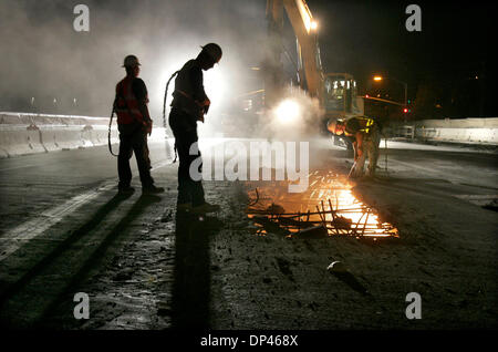 Jul 26, 2006; San Diego, CA, USA; Workers from Harber Company, of San Bernardino, demolish the Carmel Mountain Bridge over I-15. The large machine in the distance is a 40 ton excavator breaking hole in the concrete bridge as a worker at right uses a torch to cut the steel rebar. Mandatory Credit: Photo by Charlie Neuman/SDU-T/ZUMA Press. (©) Copyright 2006 by SDU-T Stock Photo