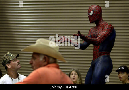 Jul 28, 2006; West Palm Beach, FL, USA; A life size replica of Spiderman captures the attention of shoppers at the 16th annual Gigantic Garage Sale, including Ron Bradshaw (far left) of Lake Worth.  Spiderman was one of the items being offered by Robert Shuster (foreground w/hat) of Hollywood.  The sale took place at the South Florida Fairgrounds Expo center. Mandatory Credit: Phot Stock Photo