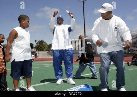 Jul 29, 2006; San Pablo, CA, USA; Contra Costa College linebackers coaches, DAVE JOHNSON (center) and GEORGE PYE (right), work with DEL LYLES, 10, during the BSAA (Black Sports Agents Association) sports and dance clinic at Contra Costa College. The clinic, thrown by Andre Farr, a former Kennedy High School and UCLA football player, featured motivational speakers and professional c Stock Photo