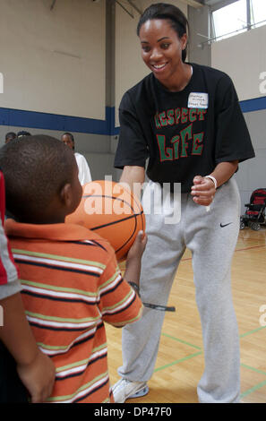 Jul 29, 2006; San Pablo, CA, USA; CHANTEA MCINTYRE, who played college basketball at Fresno State, works with a participant during basketball instruction at the BSAA (Black Sports Agents Association) sports and dance clinic at Contra Costa College. The clinic, thrown by Andre Farr, a former Kennedy High School and UCLA football player, featured motivational speakers and professiona Stock Photo