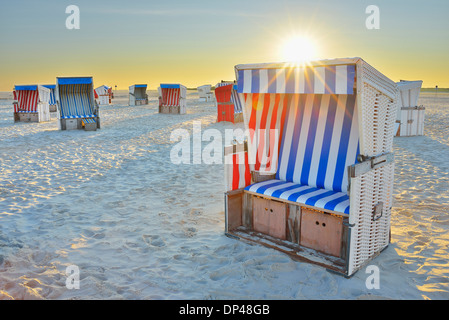 Sun Rising over Beach Chairs at Beach, Norderdeich, Sankt Peter-Ording, North Sea, Schleswig-Holstein, Germany Stock Photo