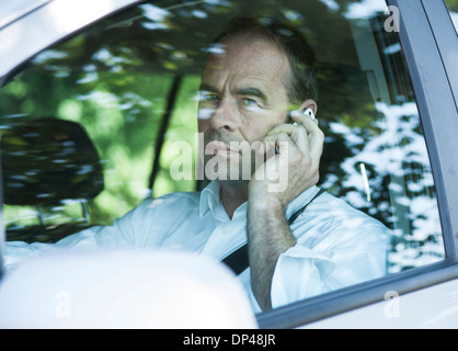 Businessman on Cellphone in Car, Mannheim, Baden-Wurttemberg, Germany Stock Photo