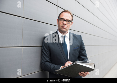 Portrait of Businessman using Tablet Computer Outdoors, Mannheim, Baden-Wurttemberg, Germany Stock Photo