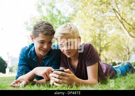 Boys using Cell Phone Outdoors, Mannheim, Baden-Wurttemberg, Germany Stock Photo