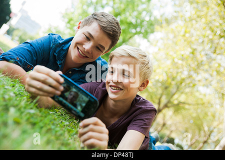 Boys taking Photo with Cell Phone Outdoors, Mannheim, Baden-Wurttemberg, Germany Stock Photo