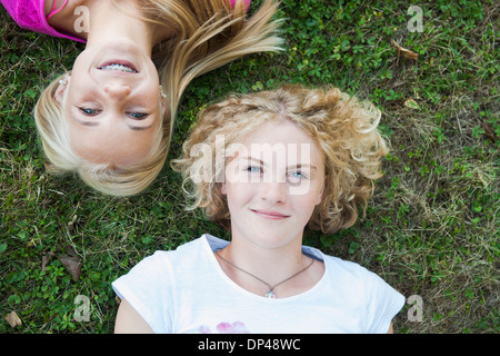 Overhead View of Teenage Girls Lying on Grass, Mannheim, Baden-Wurttemberg, Germany Stock Photo