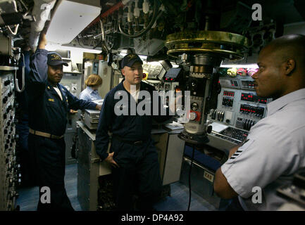 Aug 02, 2006; San Diego, CA, USA; US Navy Senior Chief Petty Officer DWAYNE HINES, left, Petty Officer Second Class DUSTON ANTHONY, and Petty Officer First Class SARITO MURRELLBASTIA right, the Superintendent of the boat talk in the Control Room on the USS Dolphin, the US Navy's last Diesel Electric Submarine. The Submarine calls Naval Base Point Loma home and is scheduled to be de Stock Photo