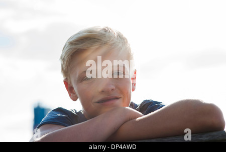 Close-up portrait of boy outdoors, smiling at camera, Germany Stock Photo