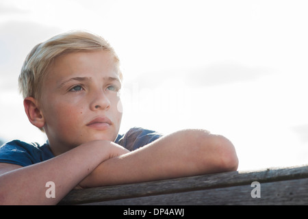 Close-up portrait of boy outdoors, looking into the distance, Germany Stock Photo