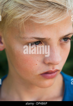 Close-up of boy outdoors, looking into the distance, Germany Stock Photo