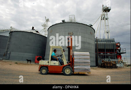 Aug 12, 2006; Dumas, TX, USA; Harold Grall moves a pallet of private-label bottled water for a client to pick up Friday, July 28, 2006 at his farm near Dumas. Grall has begun a water company, bottling water pumped from the Ogallala Aquifer, in an effort to reduce his reliance on growing irrigated corn. Estimated drought losses for Texas have reached $4.1 billion, eclipsing the $2.1 Stock Photo