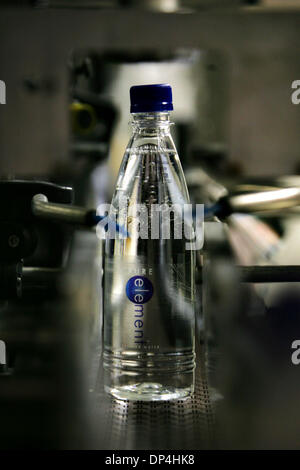 Aug 12, 2006; Dumas, TX, USA; A bottle of Pure Element bottled water moves along the assembly line after beinf filled at Harold Grall's water bottling plant on his farm Tuesday, July 25, 2006 near Dumas. Estimated drought losses for Texas have reached $4.1 billion, eclipsing the $2.1 billion mark set in 1998, Texas Cooperative Extension economists reported Aug. 11. Crop losses are  Stock Photo