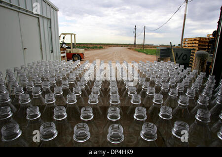 Aug 12, 2006; Dumas, TX, USA; Empty bottles are lined up before being filled with water at Harold Grall's water bottling plant Friday, July 28, 2006 on his farm near Dumas. Grall started the business as a more direct way to sell the water he's pumping from the Ogallala Aquifer, and to reduce his reliance on irrigated corn crops, which can be water-intensive. Estimated drought losse Stock Photo