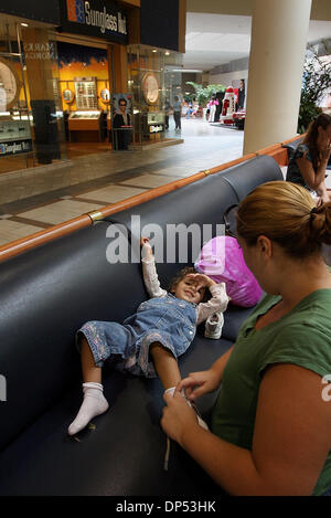 Aug 30, 2006; Boynton Beach, FL, USA; Melissa Wallace of Boynton Beach puts her daughter  Michaela Grouicha, 2, shoes on after a visit to the play area at the Boynton Beach Mall, Wednesday afternoon.  She said they visited the mall because they 'had shutters up and it was real dark inside, just to get out of the house'. Mandatory Credit: Photo by Bob Shanley/Palm Beach Post/ZUMA Pr Stock Photo