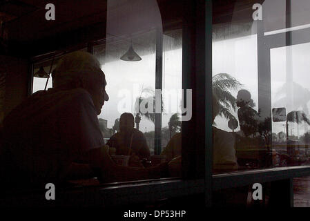 Aug 30, 2006; Boynton Beach, FL, USA; Flor Carrero sits with his wife, Lila watching the worst of Tropical Storm Ernesto at the Dunkin' Donuts during a moderate rain on Hypoluxo Rd. and Congress Ave. Wednesday morning, Aug. 30, 2006. Mandatory Credit: Photo by Chris Matula/Palm Beach Post/ZUMA Press. (©) Copyright 2006 by Palm Beach Post Stock Photo
