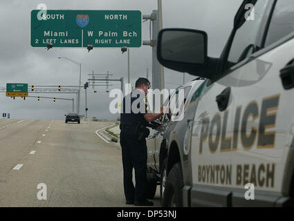 Aug 30, 2006; Boynton Beach, FL, USA; Boynton Beach Police Sgt. Steve Wessendorf (cq) writes up a speeding ticket during a stop on Gateway Blvd. Wednesday morning, Aug. 30, 2006. The Department expected much more activity, the worst of which would come from Tropical Storm Ernesto. Wessendorf commented that it was like Thanksgiving morning with the lack of activity on the streets. M Stock Photo