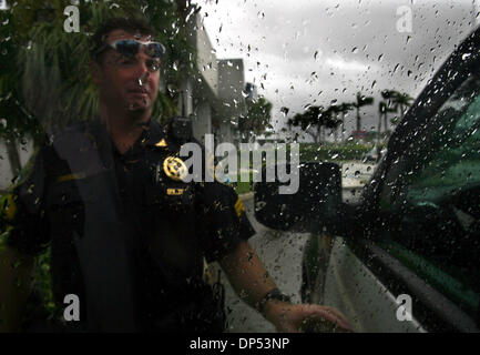 Aug 30, 2006; Boynton Beach, FL, USA; Boynton Beach Police Sergeant Steve Wessendorf (cq) returns to his vehicle after checking out an alarm at a Congress Ave. bank in a driving rain Wednesday morning, Aug. 30, 2006. The Department expected much more activity, the worst of which would come from Tropical Storm Ernesto.  Mandatory Credit: Photo by Chris Matula/Palm Beach Post/ZUMA Pr Stock Photo