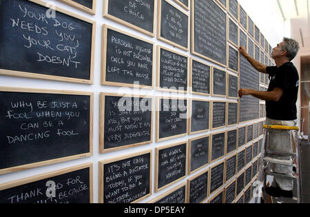 Sep 13, 2006; Boca Raton, FL, USA; Artist TIM CURTIS of Miami adjusts one of the 700 chalkboards that go into his piece titled 'Please keep your internal dialogue internal' in the hallway of the Schmidt Center at Florida Atlantic University, Wednesday afternoon. It's part of the South Florida Cultural Consortium Visual and Media Artists Fellowship Exhibition, which opens Friday and Stock Photo