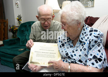 Sep 14, 2006; Havre de Grace, MD, USA; DONALD and MARGARET MERGLER, who celebrated their 80th Anniversary at the beginning of this month, look at a certificate of appreciation from Harford county in recognition of being the oldest married couple in the United States in their home in Havre de Grace on Thursday.   Mandatory Credit: Photo by James Berglie/ZUMA Press. (©) Copyright 200 Stock Photo