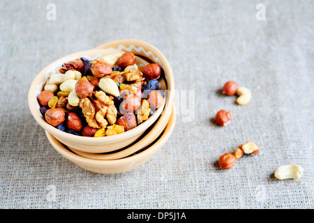 mix nuts - walnuts, hazelnuts, almonds, raisins, food closeup Stock Photo