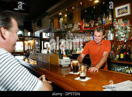 Sep 20, 2006; West Palm Beach, FL, USA; Maurice Costigan, 41, owner of O'Shea's Irish Pub serves a beer to Scott Jones one of his regular customer Tuesday on Clematis street in West Palm Beach. Costigan is fighting a 100 percent increase of his business tax, from $15,000 to $30,000.  Mandatory Credit: Photo by Bill Ingram/Palm Beach Post/ZUMA Press. (©) Copyright 2006 by Palm Beach Stock Photo