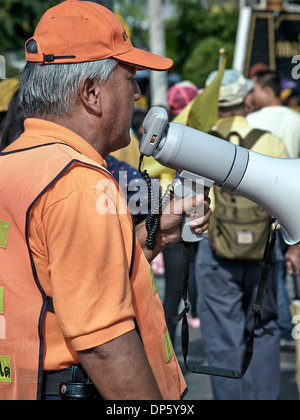 Man using a bullhorn to address a crowd Stock Photo