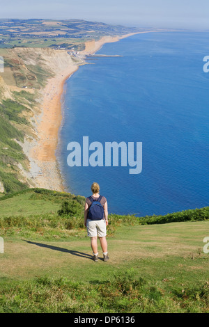 Female walker takes in the stunning views of the Dorset coastline and countryside. Stock Photo