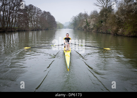 One man in a single scull rowing boat on the river Avon in Bath, UK. Stock Photo