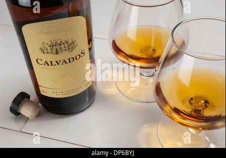 Bottle of French Calvados apple brandy with two glasses Stock Photo