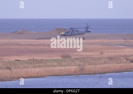 Cley-next-the-sea, Norfolk, UK . 08th Jan, 2014.  Pave Hawk crashed 8pm 7th January 2014on shingle bank at  nature reserve. USAF crew of four killed.  An intact accompanying aircraft sits on the shingle with wreckage of the lost aircraft just visible this side of it. Credit:  John Worrall/Alamy Live News Stock Photo
