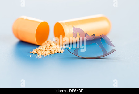 vitamins in capsules and toy horse Stock Photo