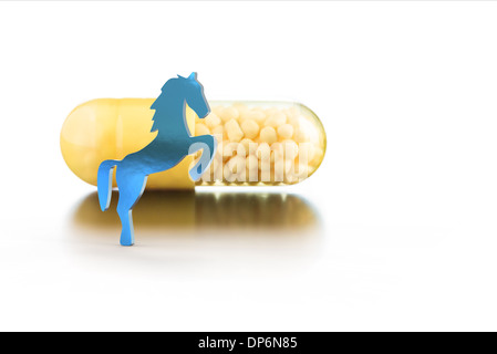 vitamins in capsules and toy horse Stock Photo