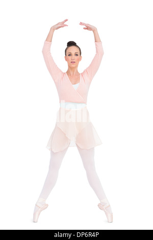 Focused attractive ballerina standing on her tiptoes Stock Photo