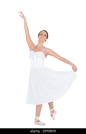 Smiling young ballet dancer posing with her leg back Stock Photo