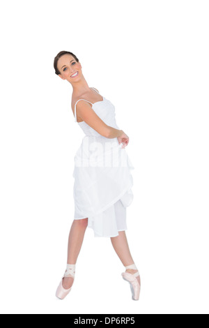 Smiling young ballet dancer standing on her tiptoes Stock Photo