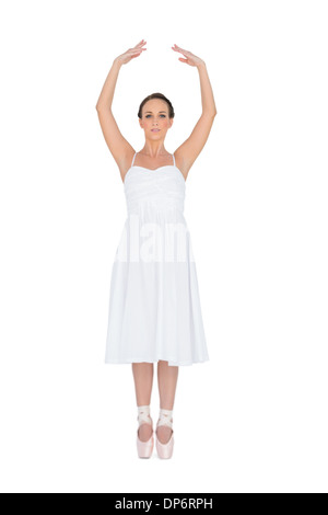 Focused young ballet dancer standing on her tiptoes Stock Photo